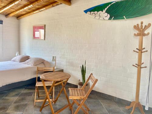 Casa Danda Punta Hermosa في بونتا هيرموسا: غرفة نوم بسرير وطاولة وكراسي