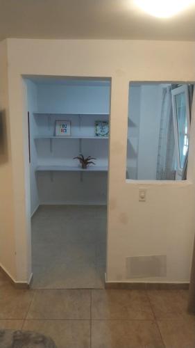 a room with a wall with shelves and a window at International House Co-Living in Medellín