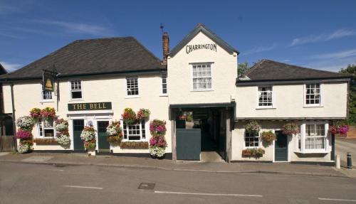 a white building with flowers in front of it at The Bell Inn Hotel in Horndon on the Hill