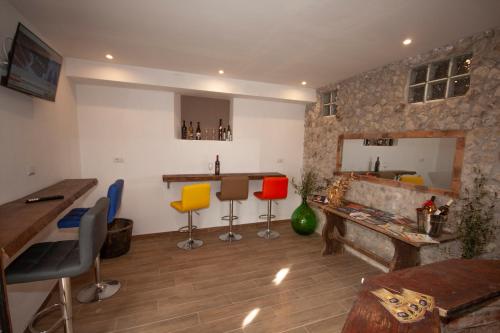 a living room with a fireplace and colorful chairs at Agriturismo L'Istrice di Giò in Montalto di Castro