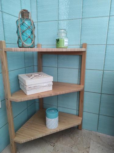 a wooden shelf with a box and a container on it at Da Marilù in Mazara del Vallo