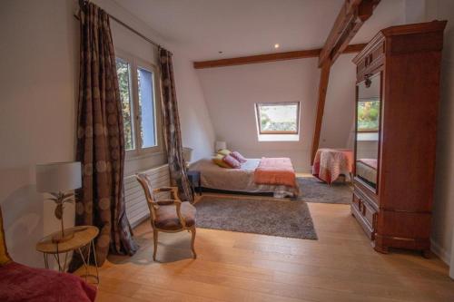 um quarto com uma cama, uma mesa e uma cadeira em Gîte La Réserve avec Jardin et Piscine em Ingersheim