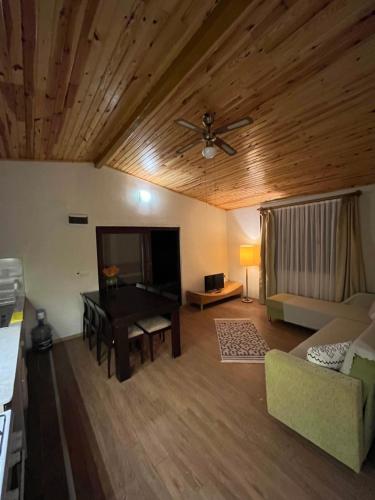 a living room with a table and a couch at Kibala Hotel in Cıralı