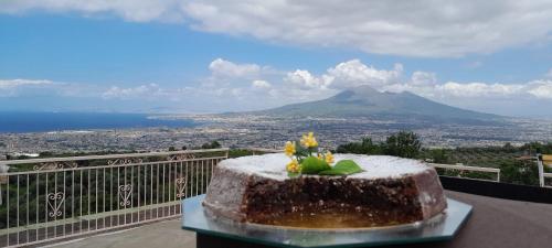 a cake on a table with a view of a mountain at La Vigna del Vento in Casola di Napoli