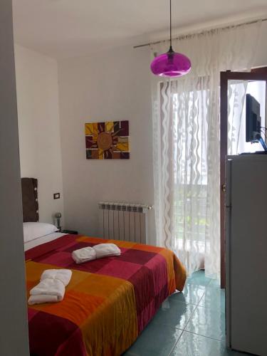 een slaapkamer met een bed met handdoeken erop bij B&B Regina Viarum in Minturno