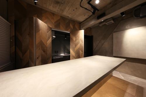 a large table in a kitchen with wooden walls at SHIN kyoto in Kyoto