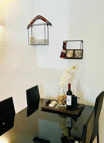 a table with two chairs and a bottle of wine at Heart of Brač in Supetar