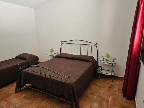 a bedroom with a bed and two side tables at Case Magliolo in Cefalù
