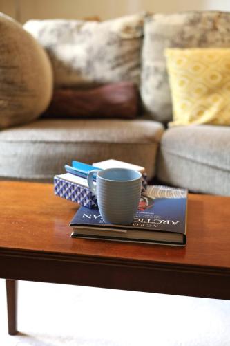 a coffee table with a coffee cup on top of it at Long Quay Apartments, Clonakilty in Clonakilty
