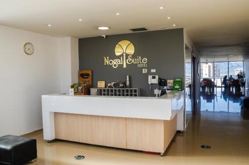 a lobby of a modern coffee shop with a counter at Nogal Suite Hotel Ipiales in Ipiales