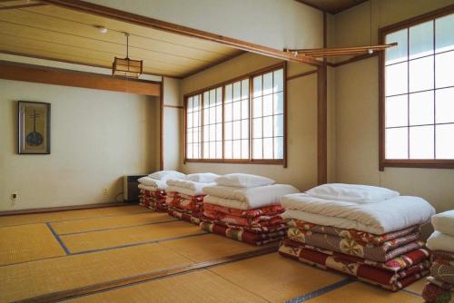 a room with a row of mattresses on the floor at Koizumiya - Vacation STAY 14238v in Yuzawa
