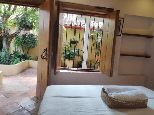 a room with a bed and a window at HOTEL NIETO MOMPOX, ubicado en el corazón del centro histórico, frente al rio magdalena en zona de malecón in Mompos