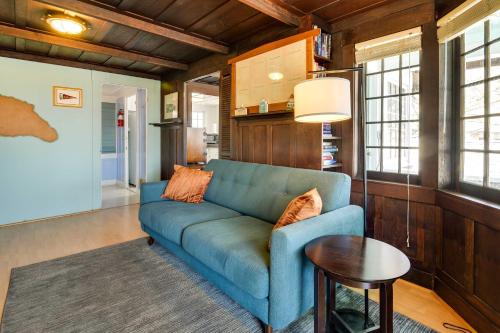 a living room with a blue couch and a table at Walk to Beach Catalina Gem with Deck! in Avalon