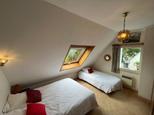 une chambre avec deux lits et une fenêtre dans l'établissement Belle demeure Perros Plage à Pieds - Ty Dour Glaz, à Perros-Guirec