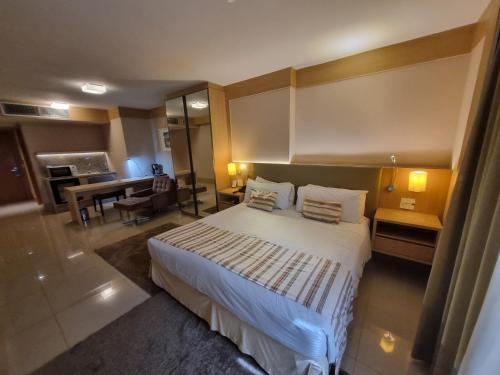 a hotel room with a bed and a desk at Cullinan apart-hotel particular in Brasília