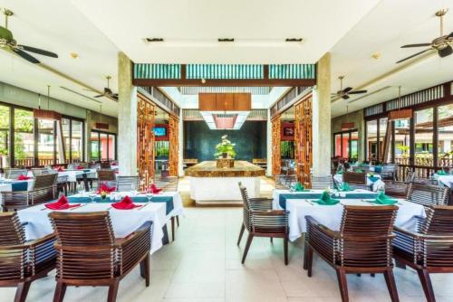 a restaurant with blue tables and chairs and a fountain at Club Wyndham Patong Hill, Phuket in Patong Beach