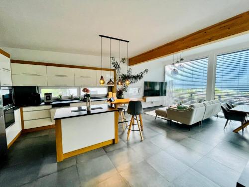 a kitchen and living room with a couch and a table at Villa Stefaner in Kirchbach