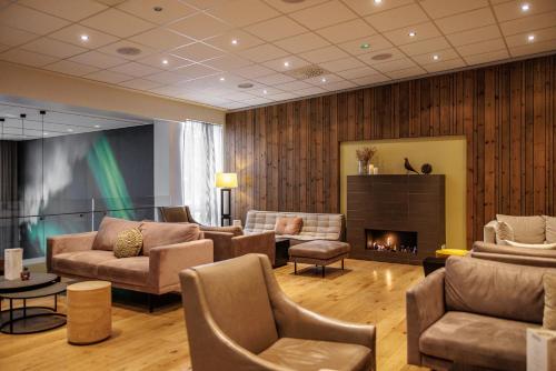 a living room with couches and a fireplace at Akureyri - Berjaya Iceland Hotels in Akureyri