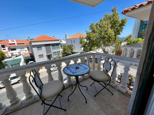 a balcony with two chairs and a table on a balcony at Eco Ljmonade Hostel in Cascais
