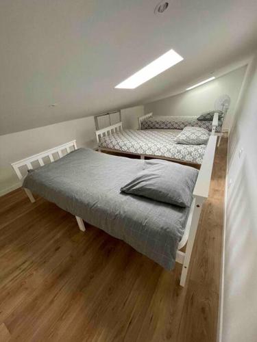 deux lits dans une chambre avec parquet dans l'établissement Magnifique appartement Narbonne, à Narbonne