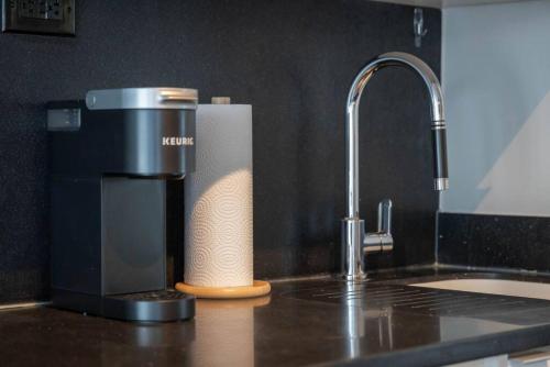 a coffee maker sitting on a kitchen counter next to a sink at Work From home with Parking WIFI and CN Tower View in Toronto