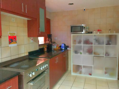 杜拜的住宿－Palm view hostel，厨房配有炉灶和微波炉。