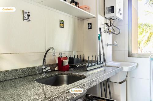 a bathroom with a sink and a counter top at Bangalô vista mar no VG Sun Cumbuco por Tactu in Cumbuco