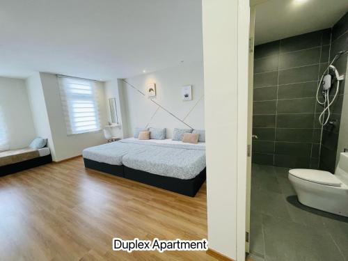 a bedroom with a bed and a shower and a toilet at The Cove Duplex 13pax 3Br 4bathroom 2parking by IWH Suites in Ipoh