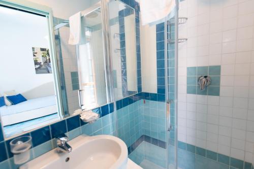 a bathroom with a sink and a glass shower at Palazzo Vingius in Minori