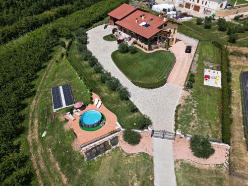 an aerial view of a house with a swimming pool at La Collina dei Ciliegi in San Mauro di Saline