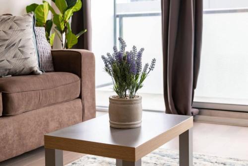 a living room with a coffee table with a plant on it at Exec 1 BR Ent District MTCC Jays with Parking in Toronto