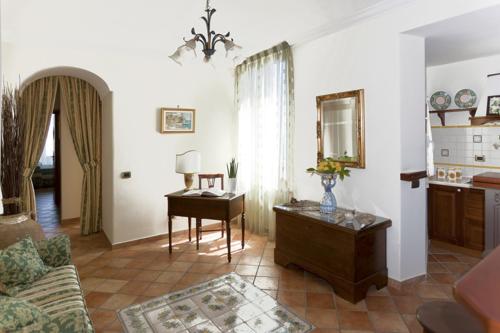 a living room with a table and a mirror at La Lanterna in Cetara