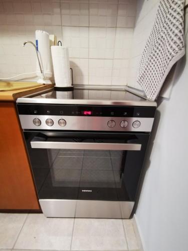 a stove top oven sitting in a kitchen at Hermes Modern Apartment in Alexandroupoli