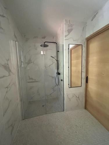 une salle de bain avec une douche avec une porte vitrée dans l'établissement Casa del Sola, à Mosset