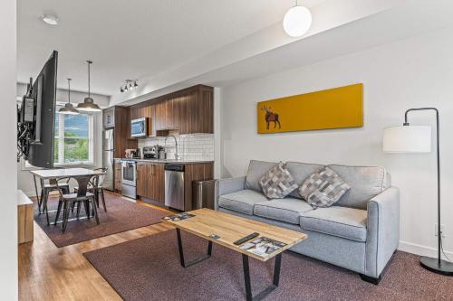 a living room with a couch and a table at Basecamp Resorts Canmore in Canmore