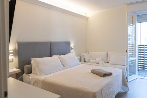 Ένα ή περισσότερα κρεβάτια σε δωμάτιο στο Kiss Beachfront Hotel & Restaurant