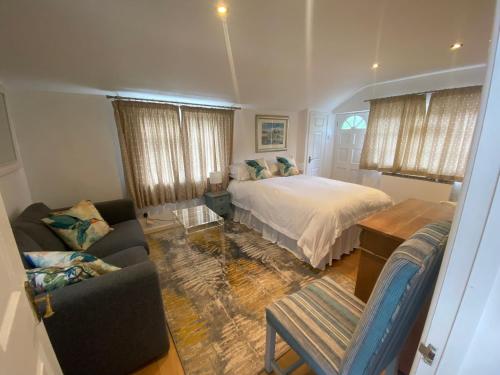 ein Schlafzimmer mit einem Bett und einem Sofa in der Unterkunft The Guesthouse hideaway in Hordle