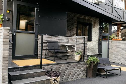a house with two chairs on a patio at loft apartments OLD MILL in Sarny