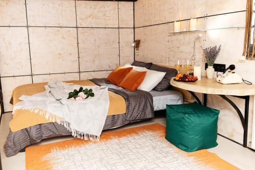 a room with a bed and a table in it at loft apartments OLD MILL in Sarny
