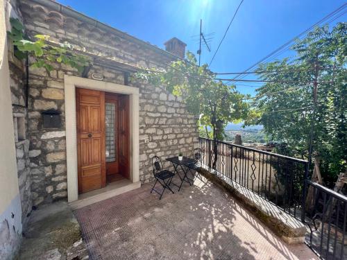 una casa de piedra con una puerta de madera en un balcón en Anima Irpina, en Gesualdo