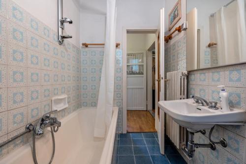 a bathroom with a sink and a bath tub at Casa nel Borgo Iris in Breguzzo