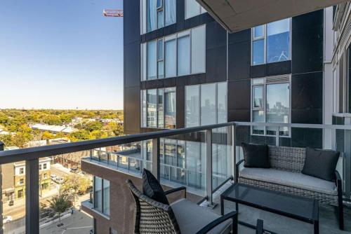 a balcony with a couch and chairs on a building at South Riverdale Suite with High speed WiFi and Balcony in Toronto