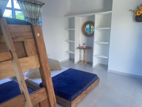 a bedroom with a bunk bed and a mirror at Casa bella de campo Wifi billar piscina bolirana !privado! in Carmen de Apicalá