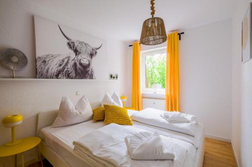 a bedroom with a bed with a picture of a cow at Pfälzer Weinperle mit Terrasse in Hainfeld