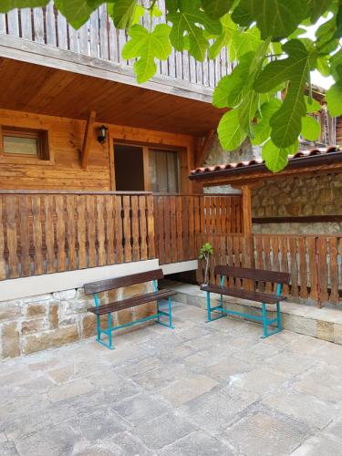 two benches sitting outside of a wooden building at Nikoli - Nesebar Traditional House in Nesebar