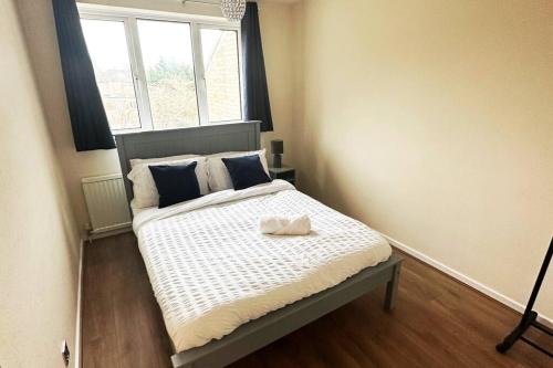 a small bedroom with a bed with a window at Lovely 3 Bed with Free parking-Families, Professionals and Contractors Welcome in Luton