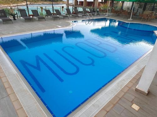 a large swimming pool with the word mt on it at Mucobega Hotel 2 in Sarandë