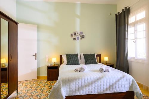 a bedroom with a bed with two towels on it at Mansion House in Neápolis
