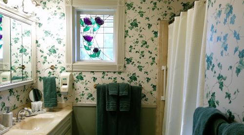 a bathroom with a sink and a window at Rock Cottage Gardens B&B in Eureka Springs