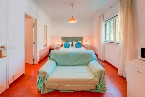 a bedroom with a bed with blue pillows at Herdade da Granja Nova in Montargil